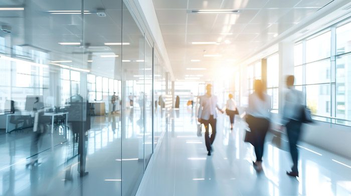 blurred business people in white glass office background